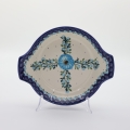 Round baking dish with handles made of Boleslawiec pottery.