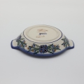 Round baking dish with handles made of Boleslawiec pottery.
