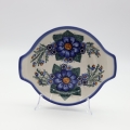 Round baking dish with handles made of Boleslawiec pottery.