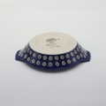 Round baking dish with handles made of Boleslawiec pottery.