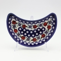 Unique Bolesławiec tray in crescent shape, perfect for serving snacks.