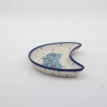 Unique Bolesławiec tray in crescent shape, perfect for serving snacks.