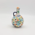Hand-painted round decanter made from traditional Bolesławiec pottery. Unique ceramic bottle perfect for serving liqueurs, water, or as a table decoration.