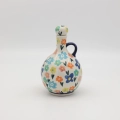 Hand-painted round decanter made from traditional Bolesławiec pottery. Unique ceramic bottle perfect for serving liqueurs, water, or as a table decoration.