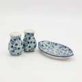 Hand-painted salt and pepper shakers with tray made from traditional Bolesławiec pottery. A stylish set perfect for everyday use and elegant table settings.