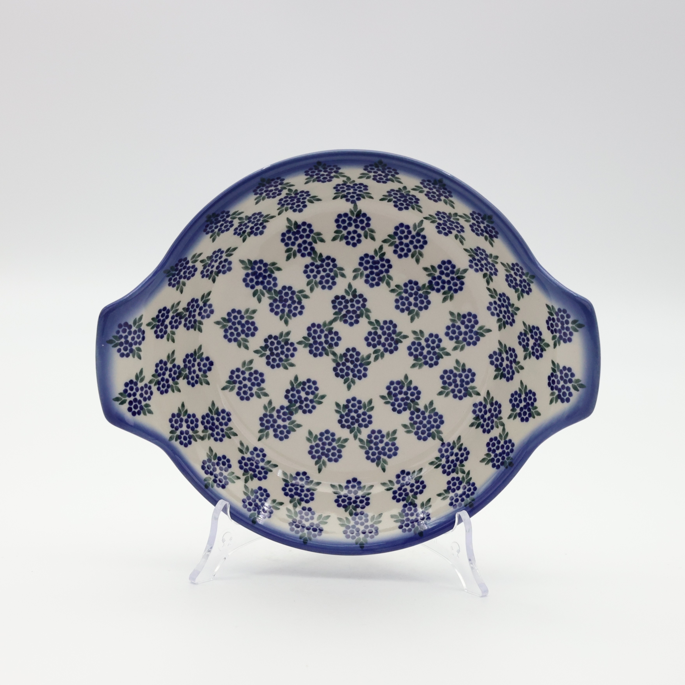 Round baking dish with handles made of Boleslawiec pottery.