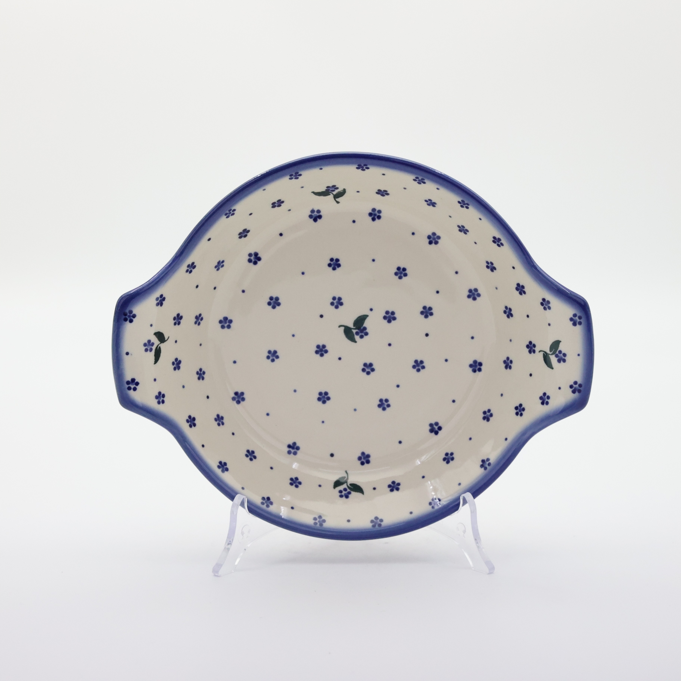 Round baking dish with handles made of Boleslawiec pottery.