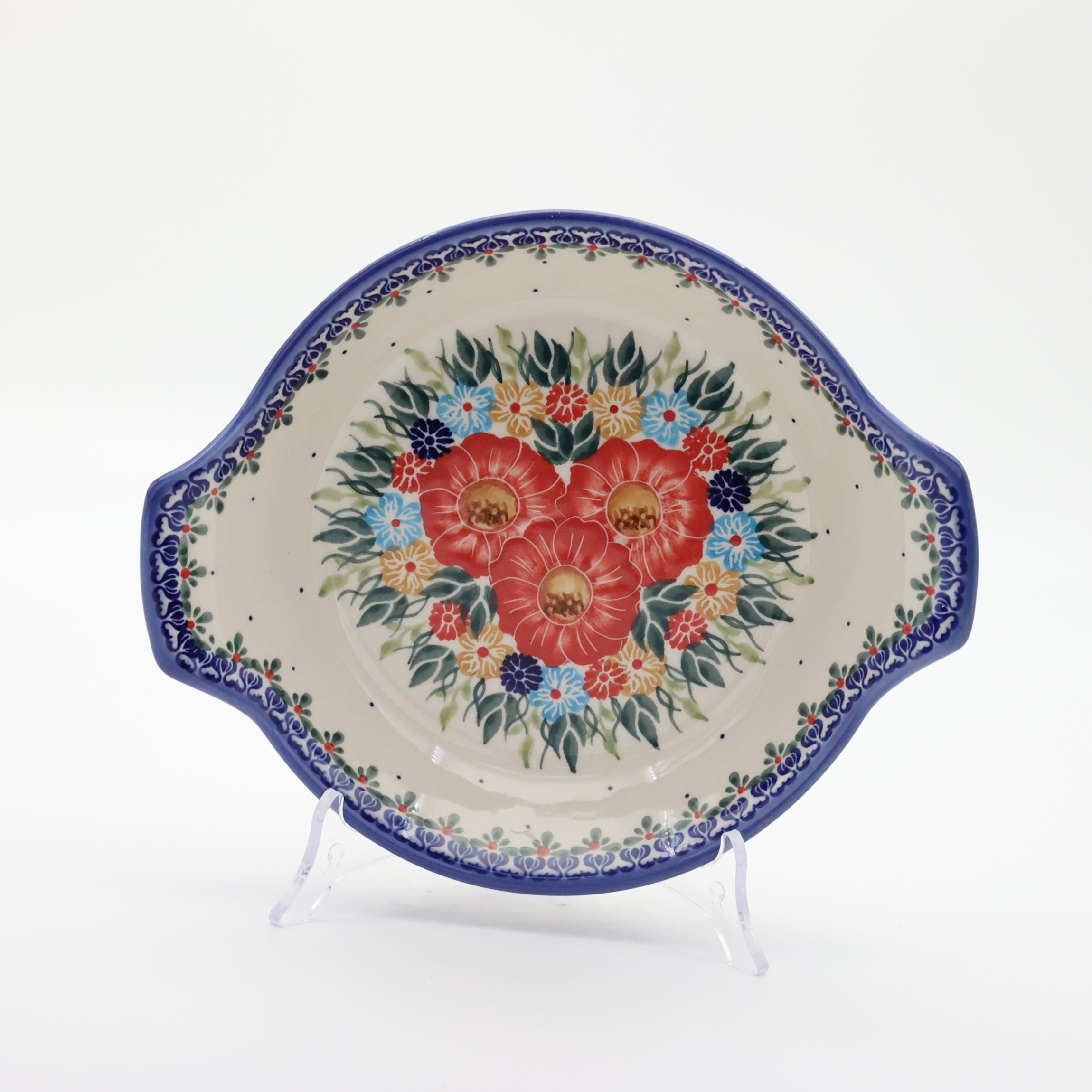 Round baking dish with handles made of Boleslawiec pottery.