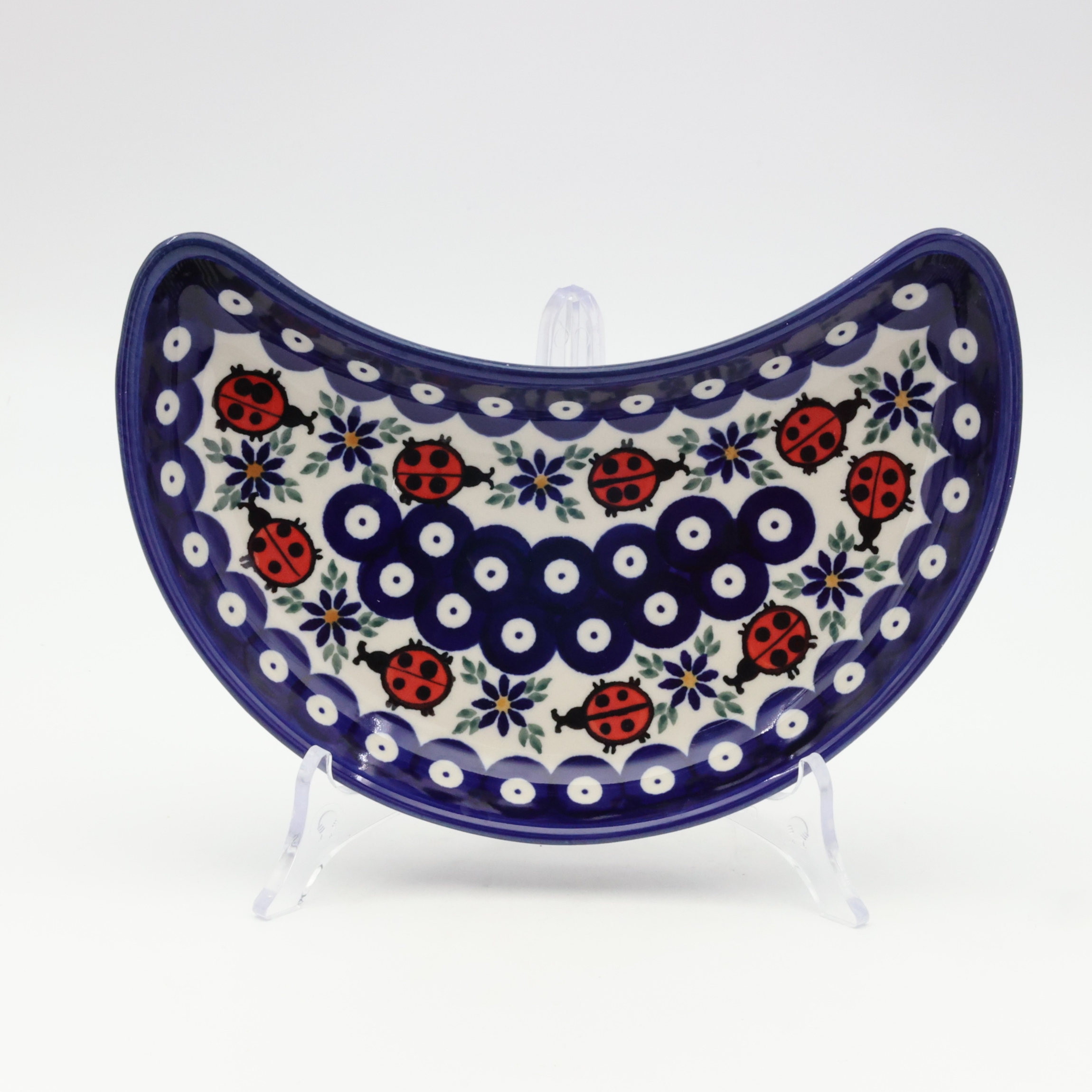 Unique Bolesławiec tray in crescent shape, perfect for serving snacks.