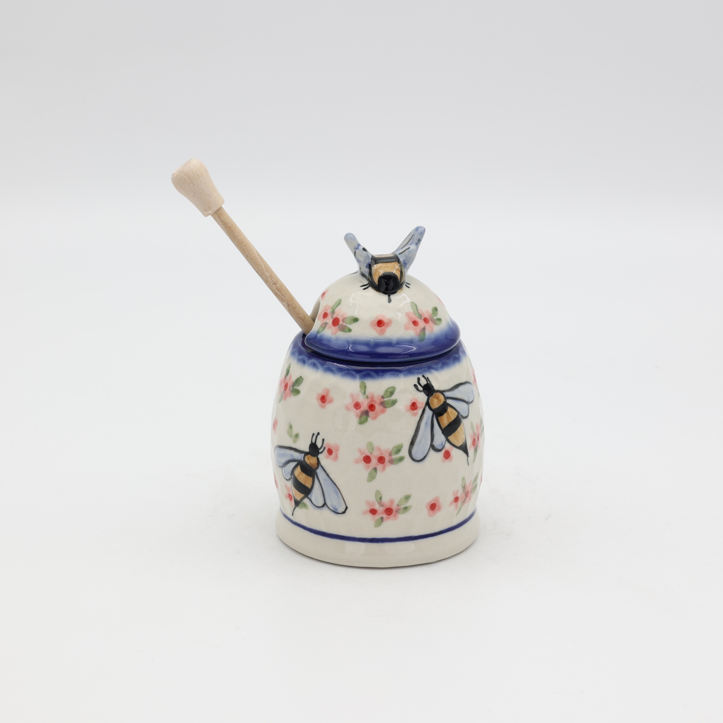 Hand-painted honey pot made from traditional Bolesławiec pottery. A stylish and practical container perfect for storing and serving honey.