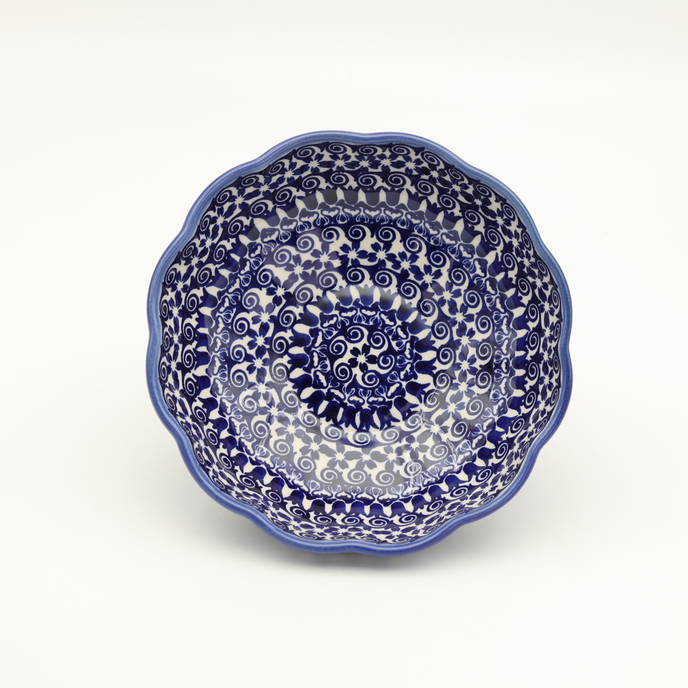 Add a touch of floral elegance to your table with the flower-shaped bowl. This unique piece from Bolesławiec stands out with its scalloped edges resembling delicate petals and intricate, hand-painted patterns.